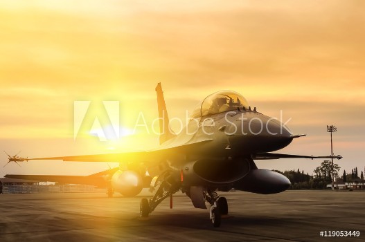 Picture of f16 falcon fighter jet parked on sunset background 